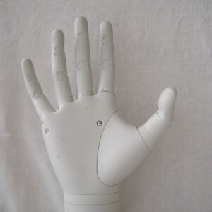 An open white robotic hand resting palm up, an AI that supports rather than criticises