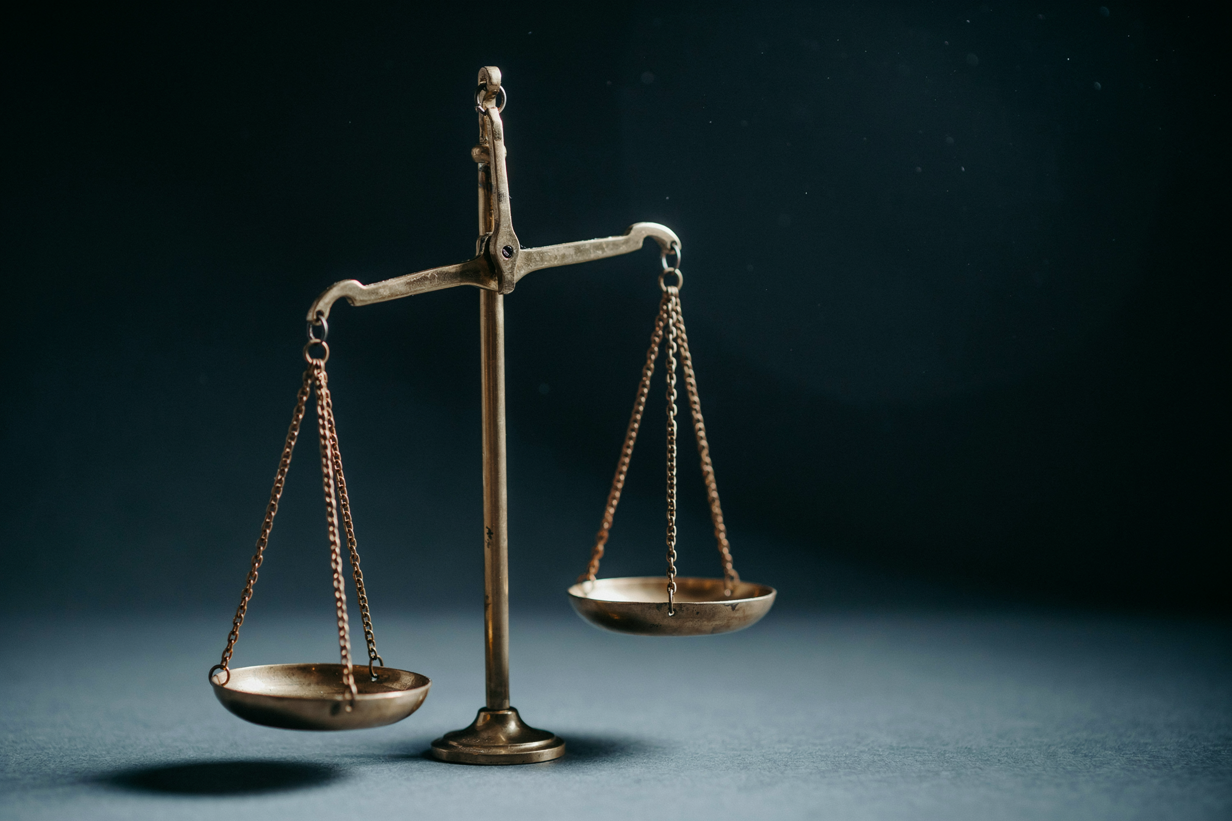 A balance scale tipped to one side, showing the tradeoff a real vision statement names