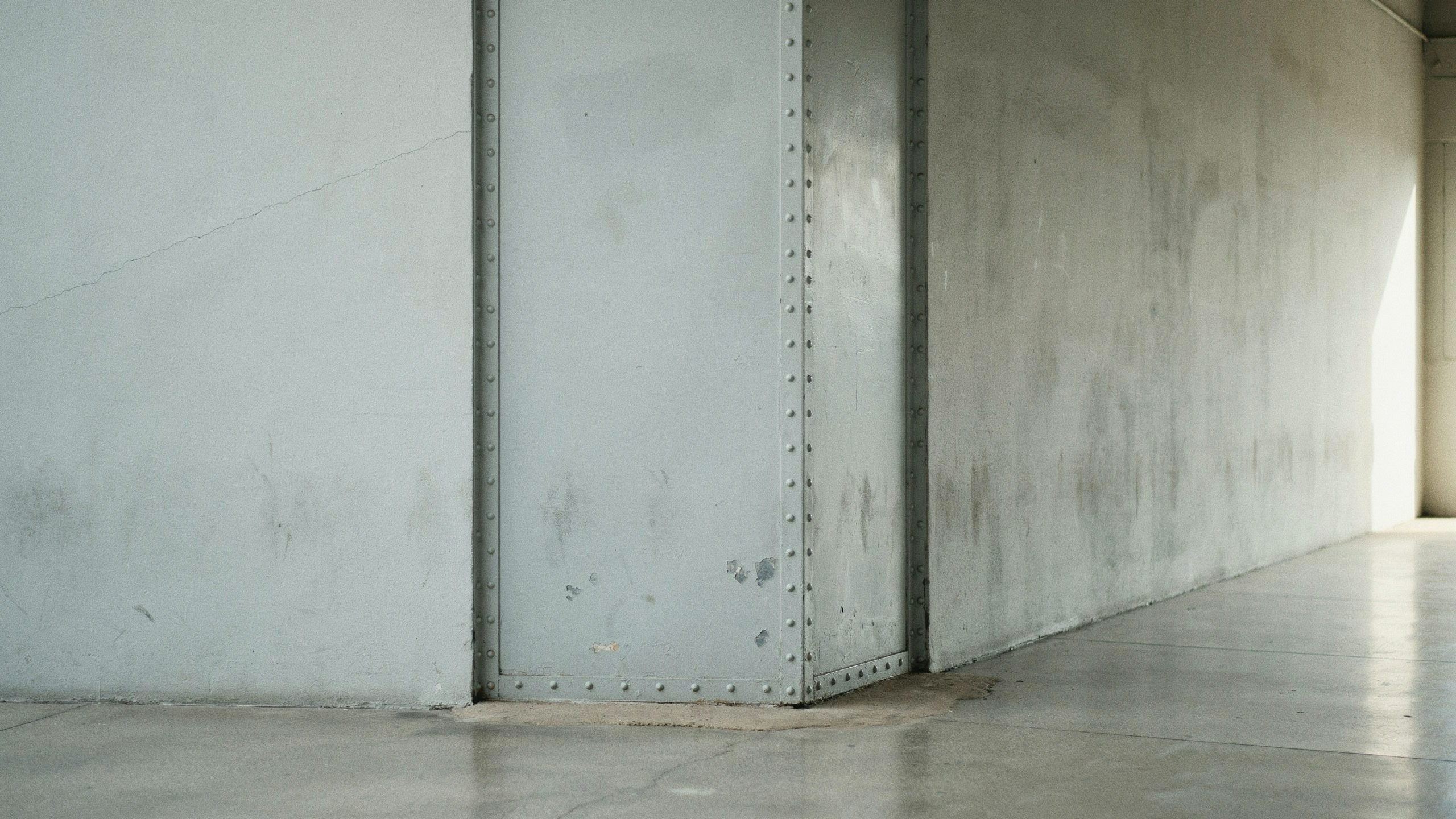 A steel door with no handle on the near side, illustrating a one-way door decision