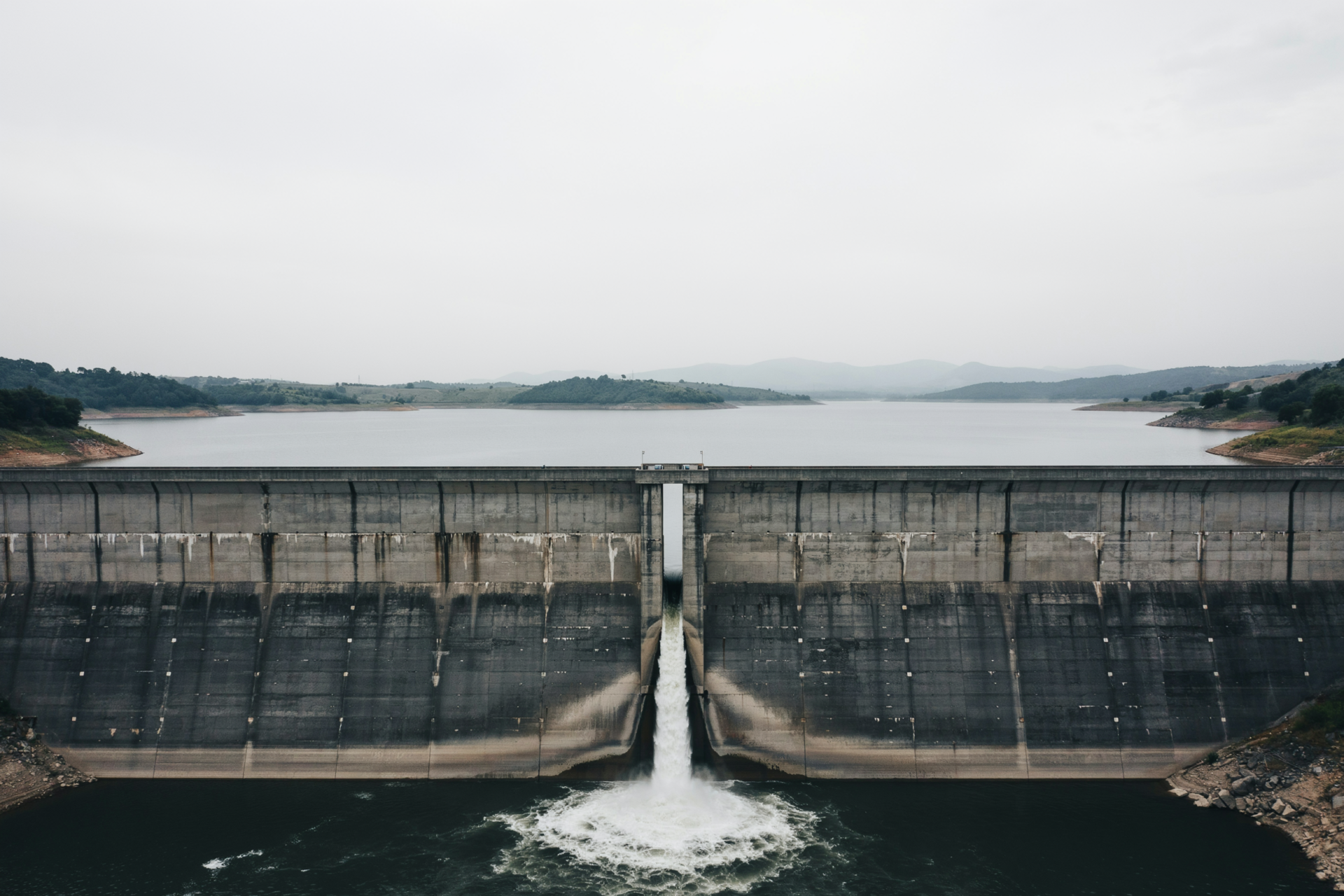 Water held back by a dam, showing how one decision redirects everything downstream