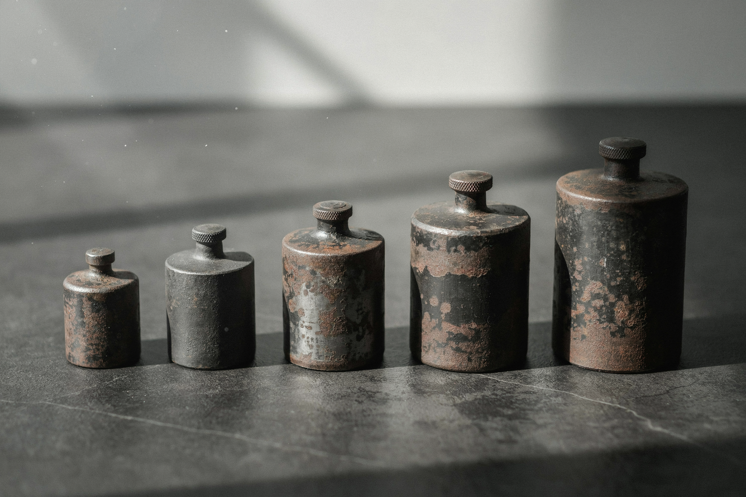 A row of cast-iron weights, the multiples buyers actually pay for a small business