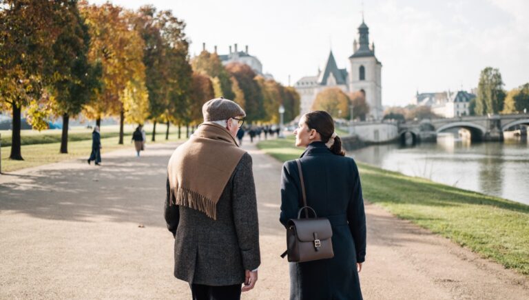 Are financial advisors worth it: an older client on a walking meeting with his adviser along a riverside path