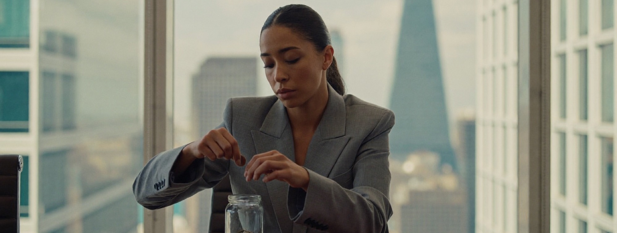 A woman counting coins from one jar into another