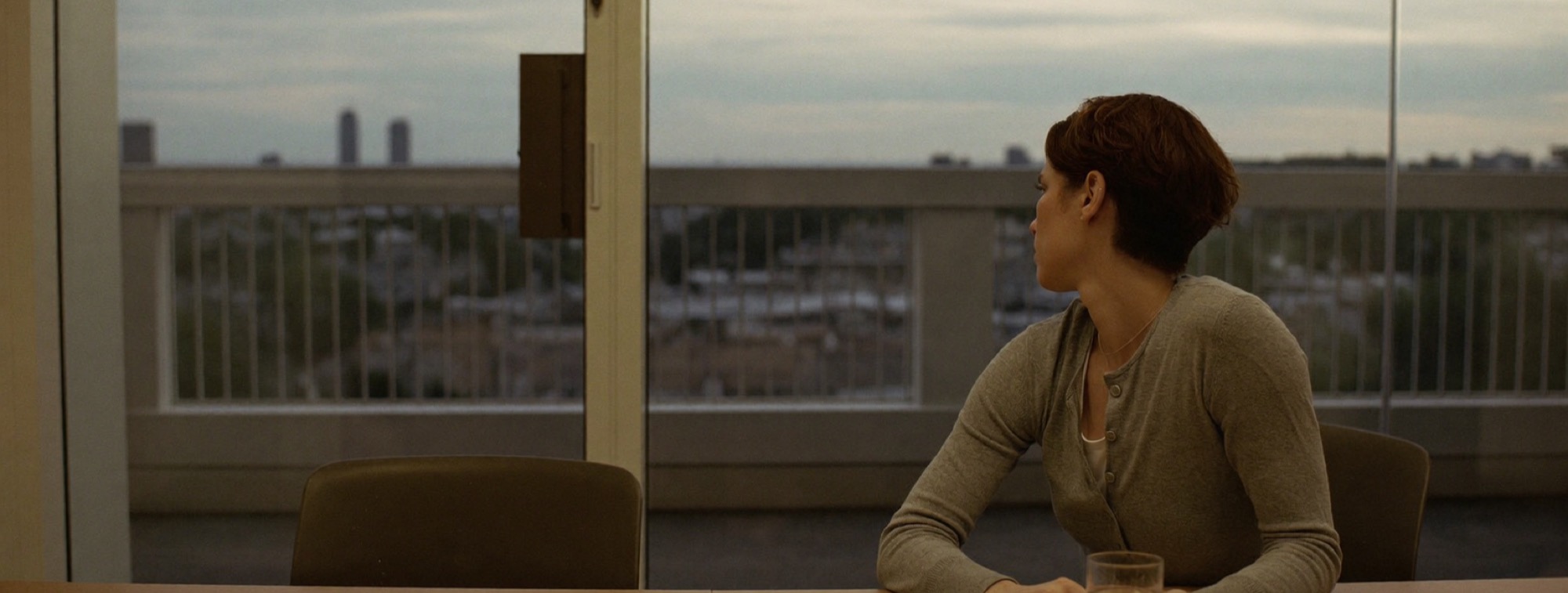 A client alone at the meeting table after the adviser has stepped out