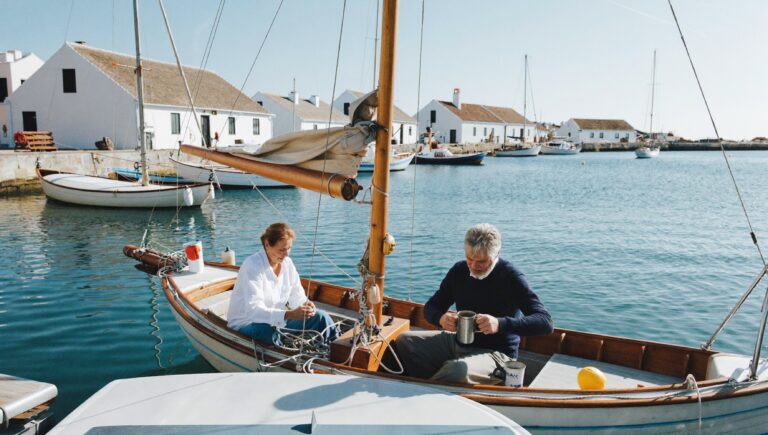 How much money is enough: a couple in their sixties on a small sailboat in a sunny harbour