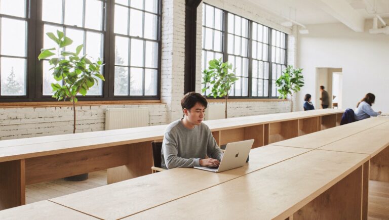 How much should I pay myself: a software founder at work in a bright co-working loft