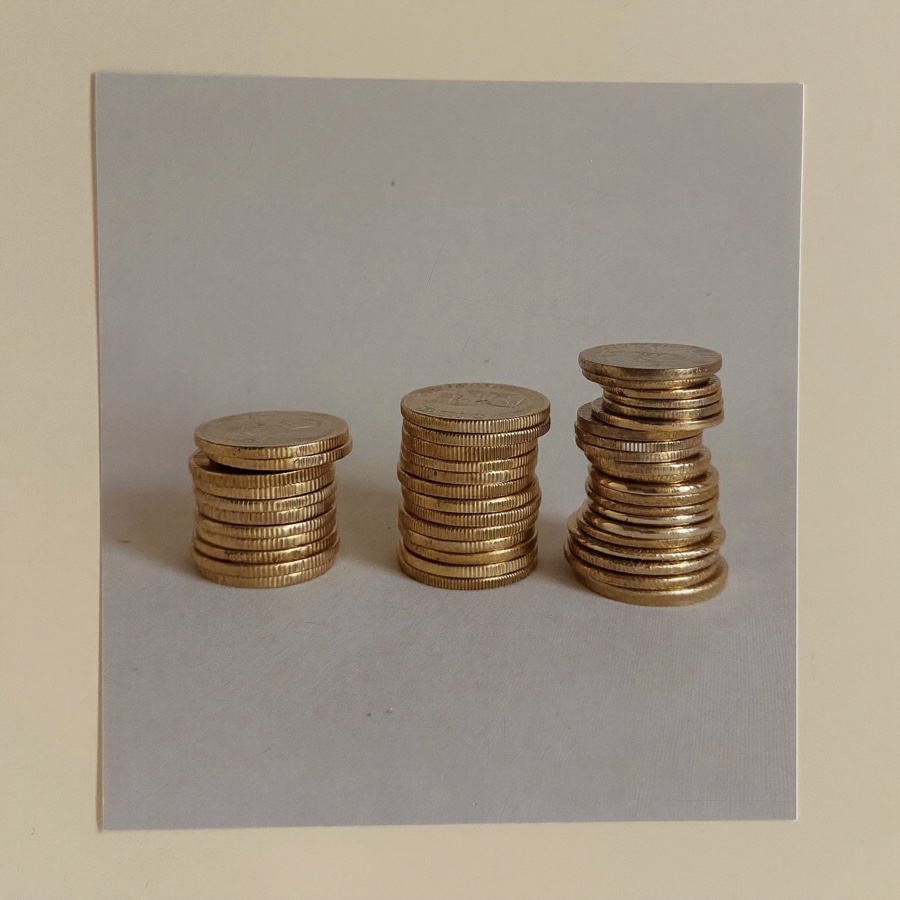 How to budget with irregular income: three stacks of gold coins of different heights