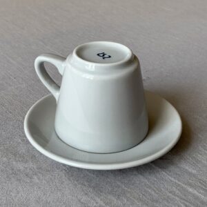 An espresso cup turned upside down on its saucer