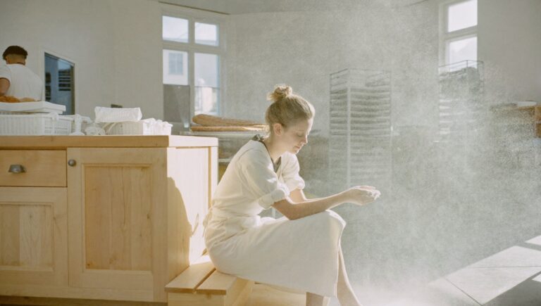 The stages of burnout: a baker resting on a step at the end of the morning shift