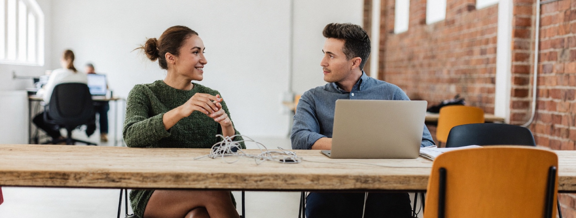 Two colleagues working through an interruption at a shared table