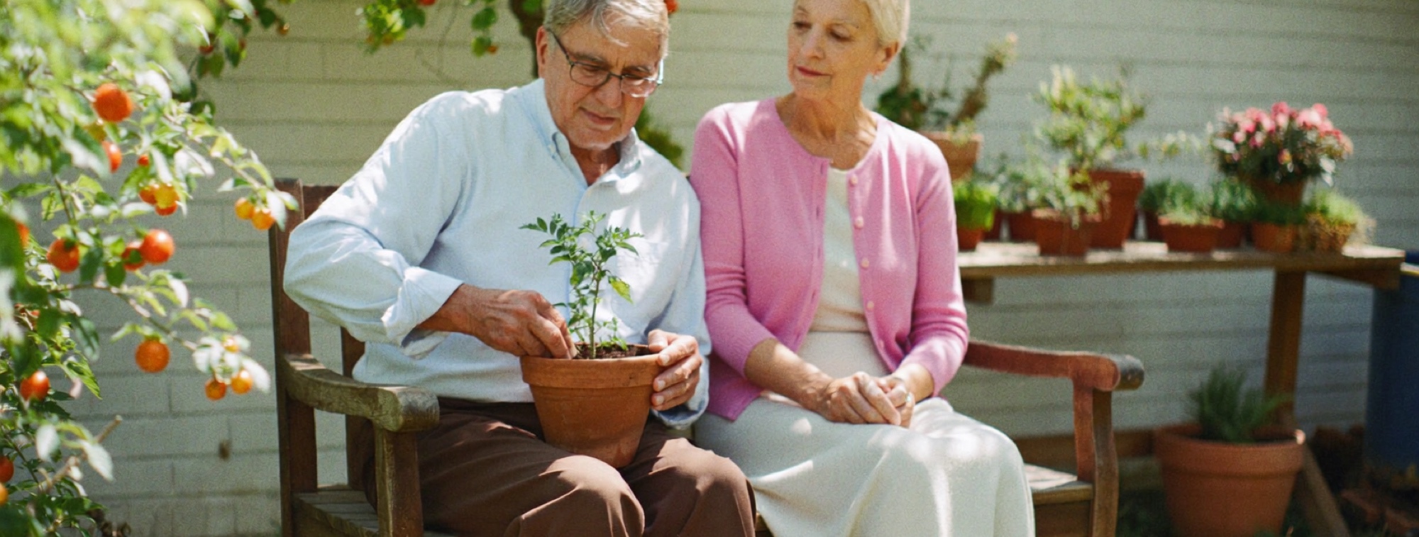 A retired couple repotting a plant in their garden, the stage of life when cover often stops being needed