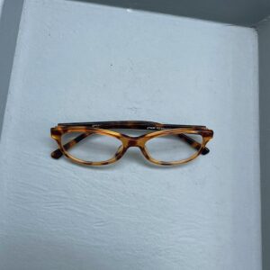 A folded pair of reading glasses, set down at the end of the working day
