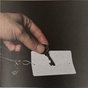 A hand setting down a key and a blank pass, the moment a business gains an employee