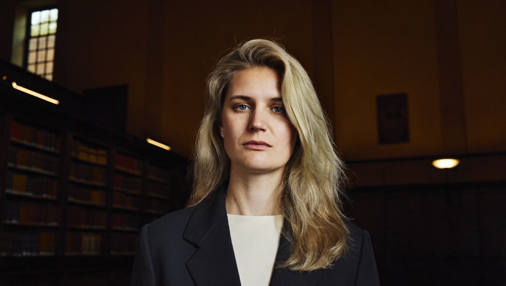 A graduate in a university library, weighing what the qualification actually bought