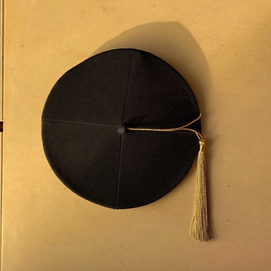 A mortarboard on a desk, the qualification at the centre of the question