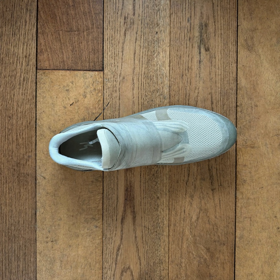 A single running shoe on an oiled oak floor