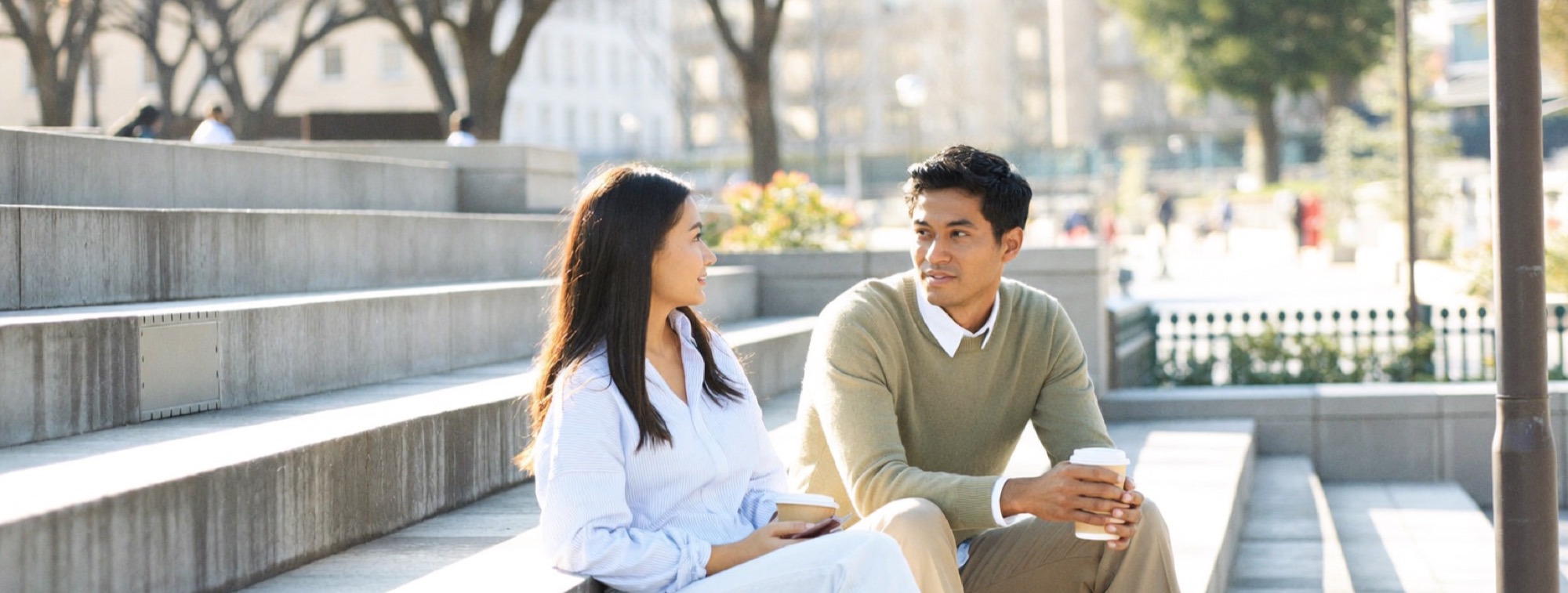 The billionaire mindset leaves out chance: two strangers starting a conversation on sunlit steps