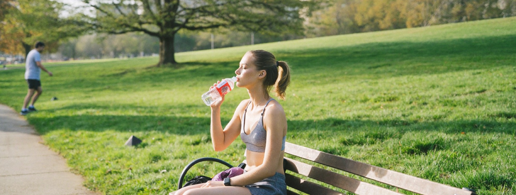 A woman resting on a park bench after an early morning run