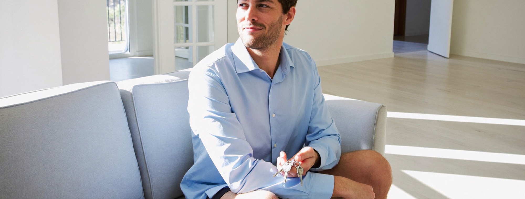 The Alex Hormozi decision framework in real life: a man holding the keys to a new, empty home