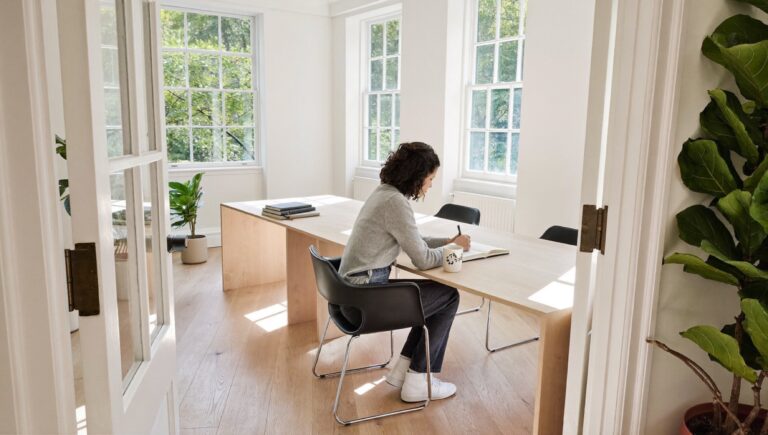 Why do I never finish anything: a founder at a bright desk with one project in front of her and the rest set aside