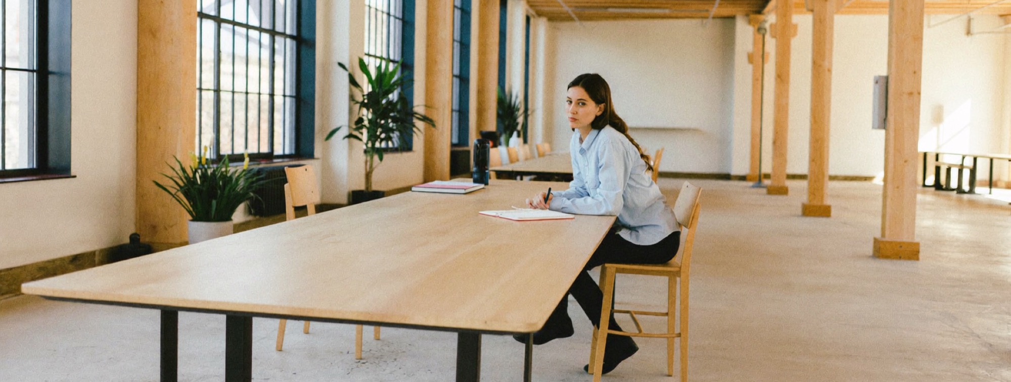 A founder at a wide empty table working on one project, the others set aside