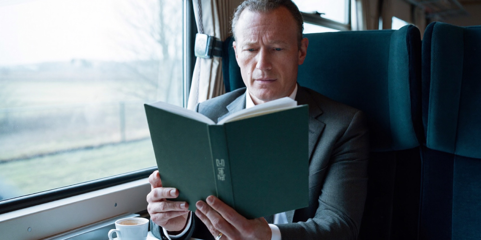 An executive reading on a train, one long stretch with no interruptions