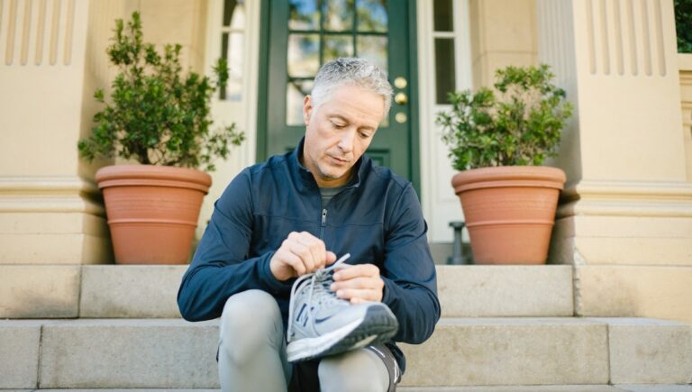 A chief executive tying his running shoes before work, the most common habit in the morning routines of successful people