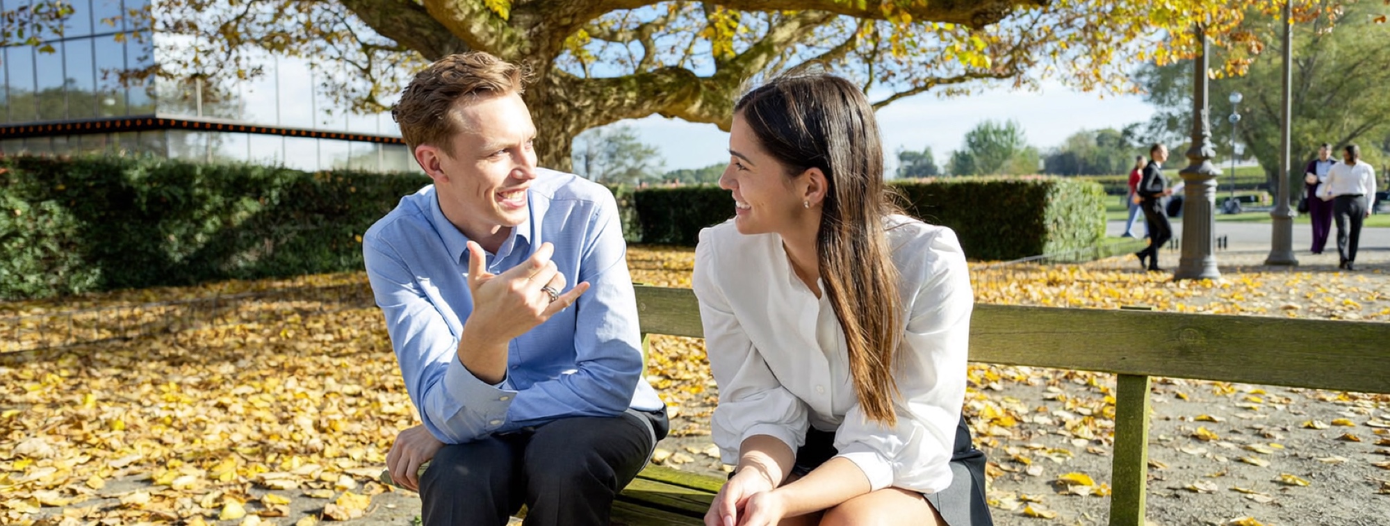 Two colleagues talking a problem through on a bench outside the office