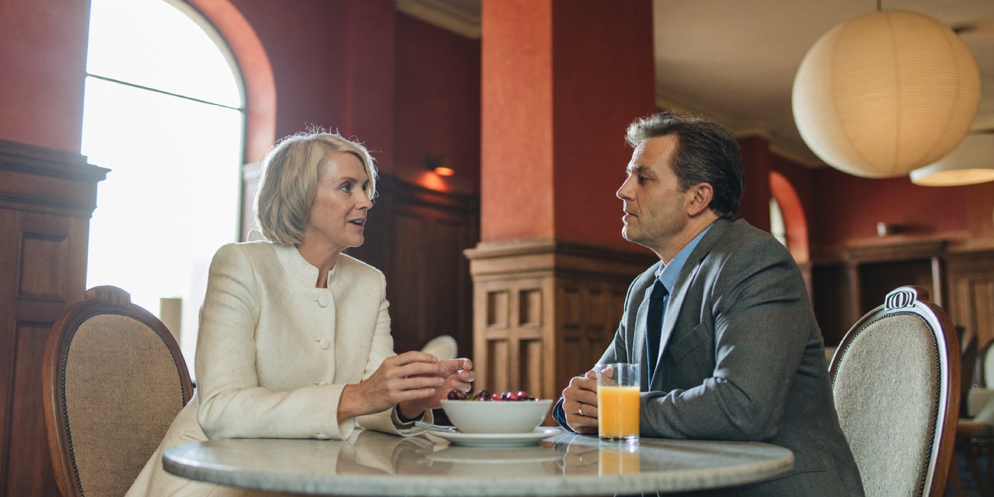A chief executive and her chief of staff planning the day over breakfast in morning light