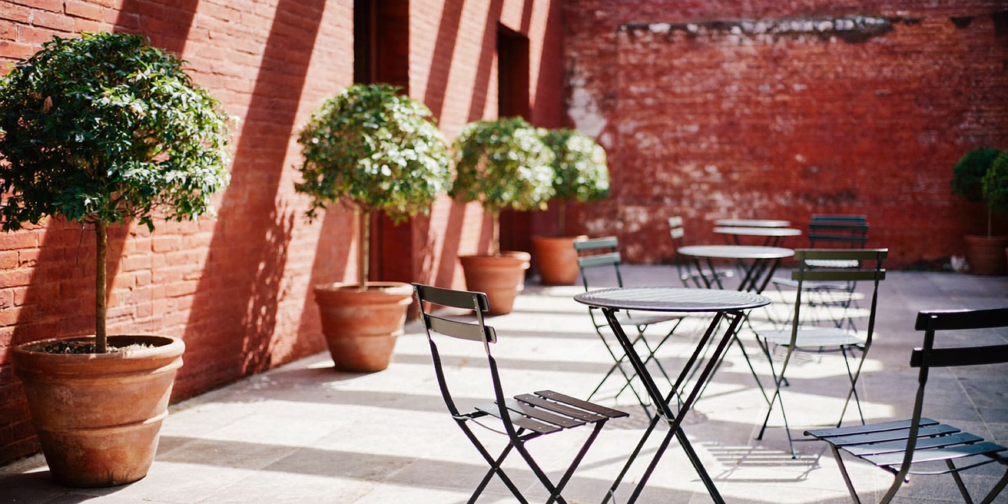 The empty terrace of a members' club in the morning, the hour an introvert should arrive
