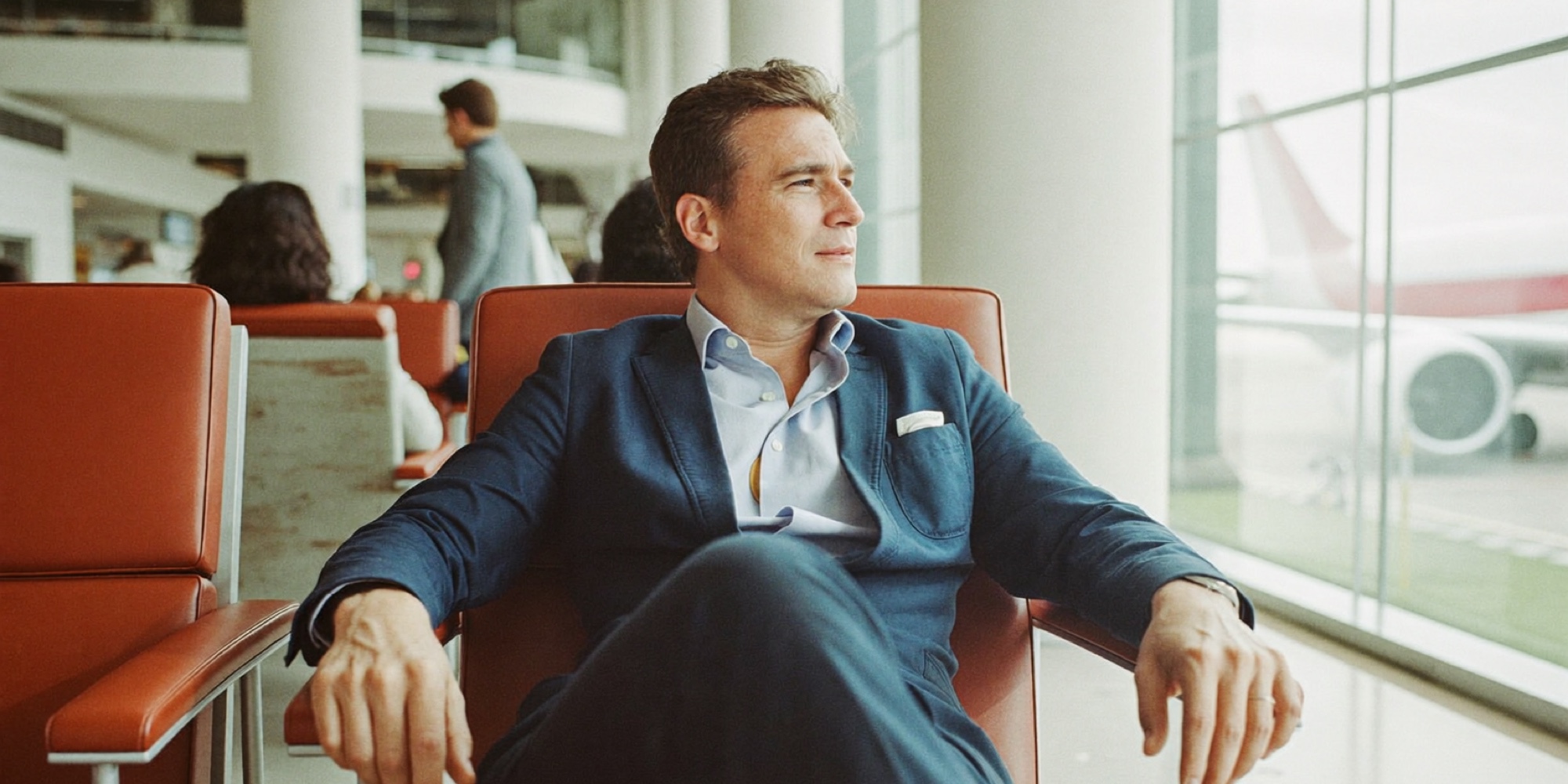 An executive waiting for a flight to a class weekend, the time cost of the programme that the tuition page never mentions
