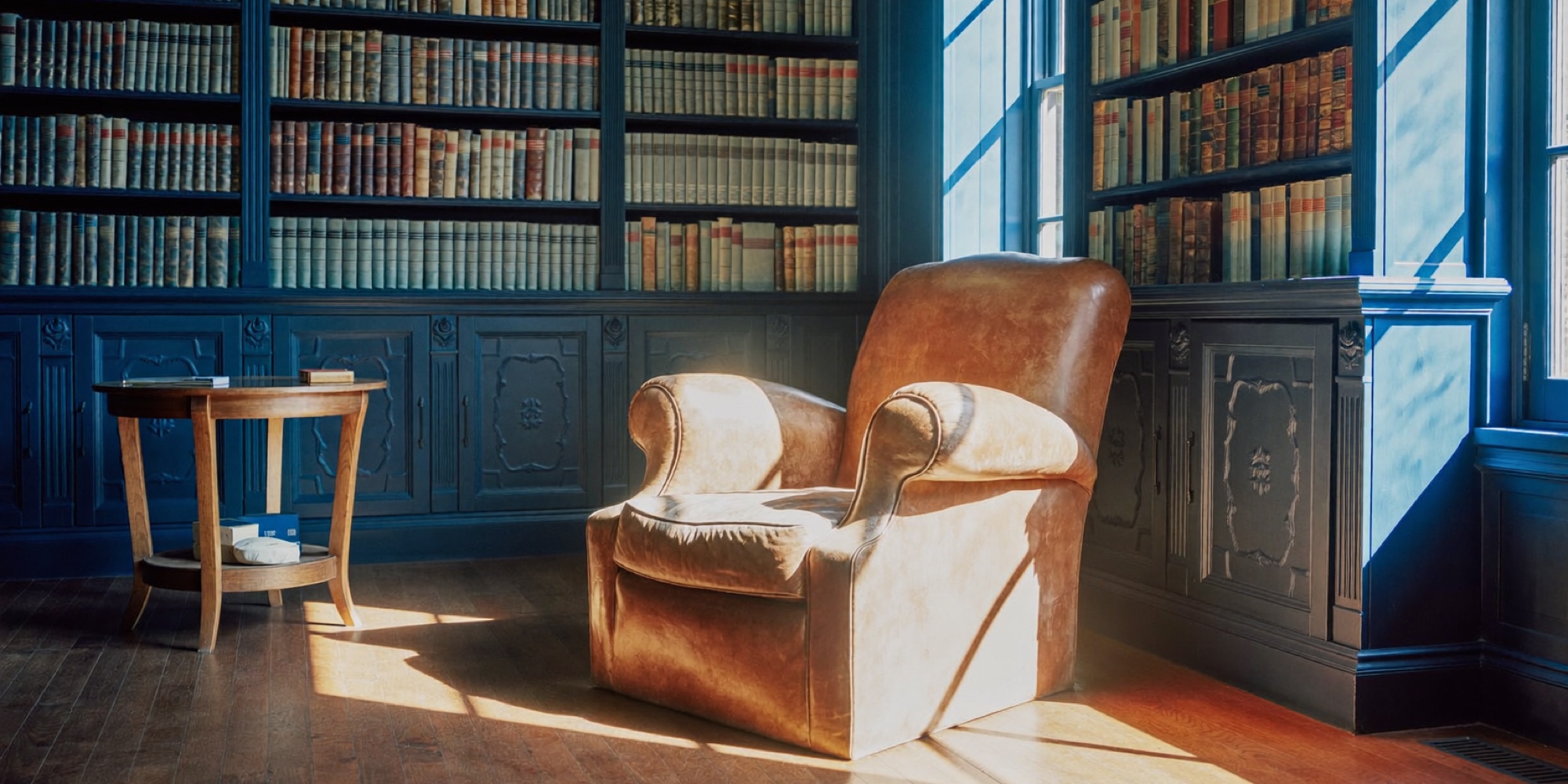 A deep blue home library, the kind of room where Bill Gates book recommendations get read in full