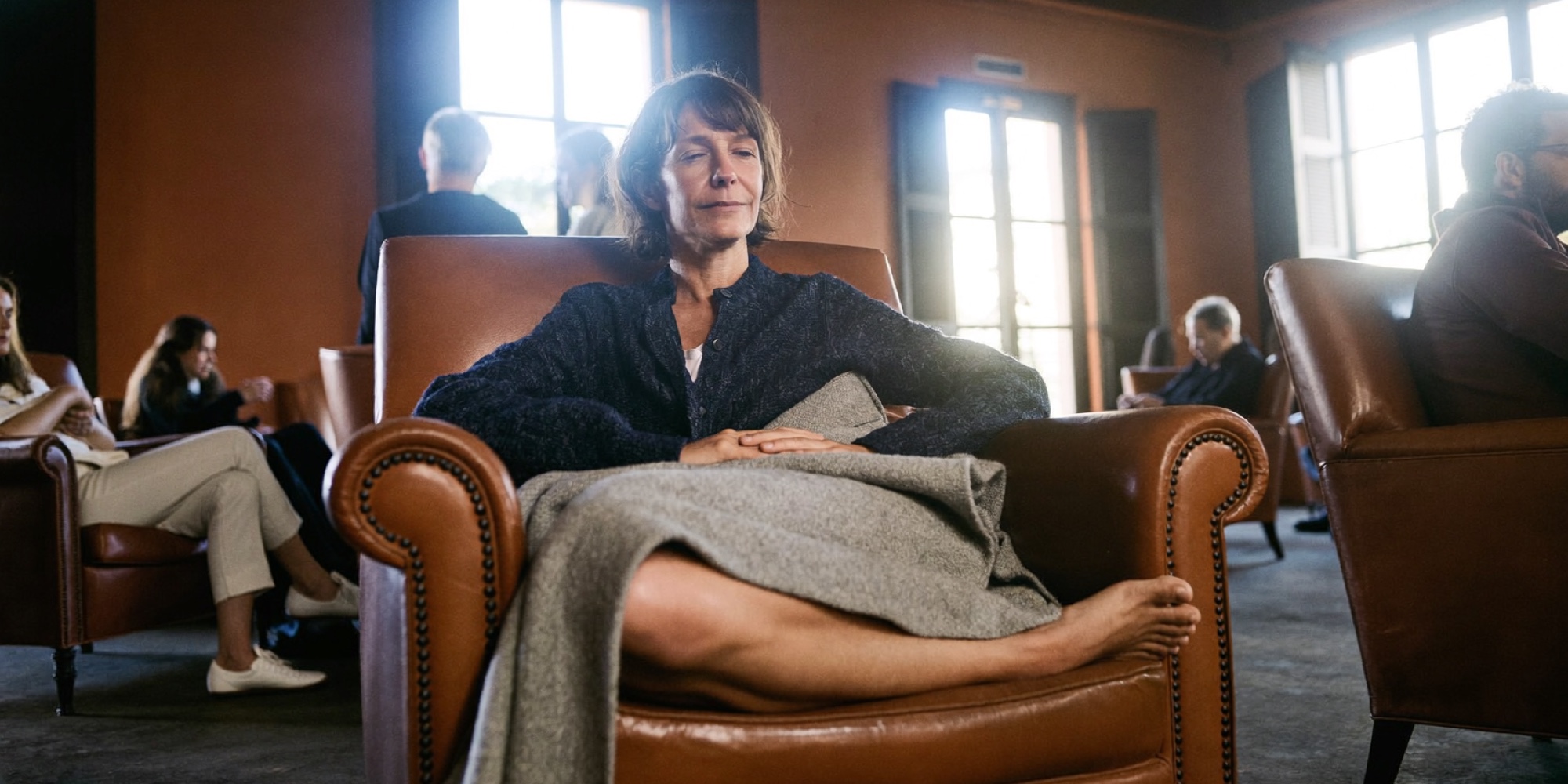 A director winding down in a quiet lounge an hour before bed