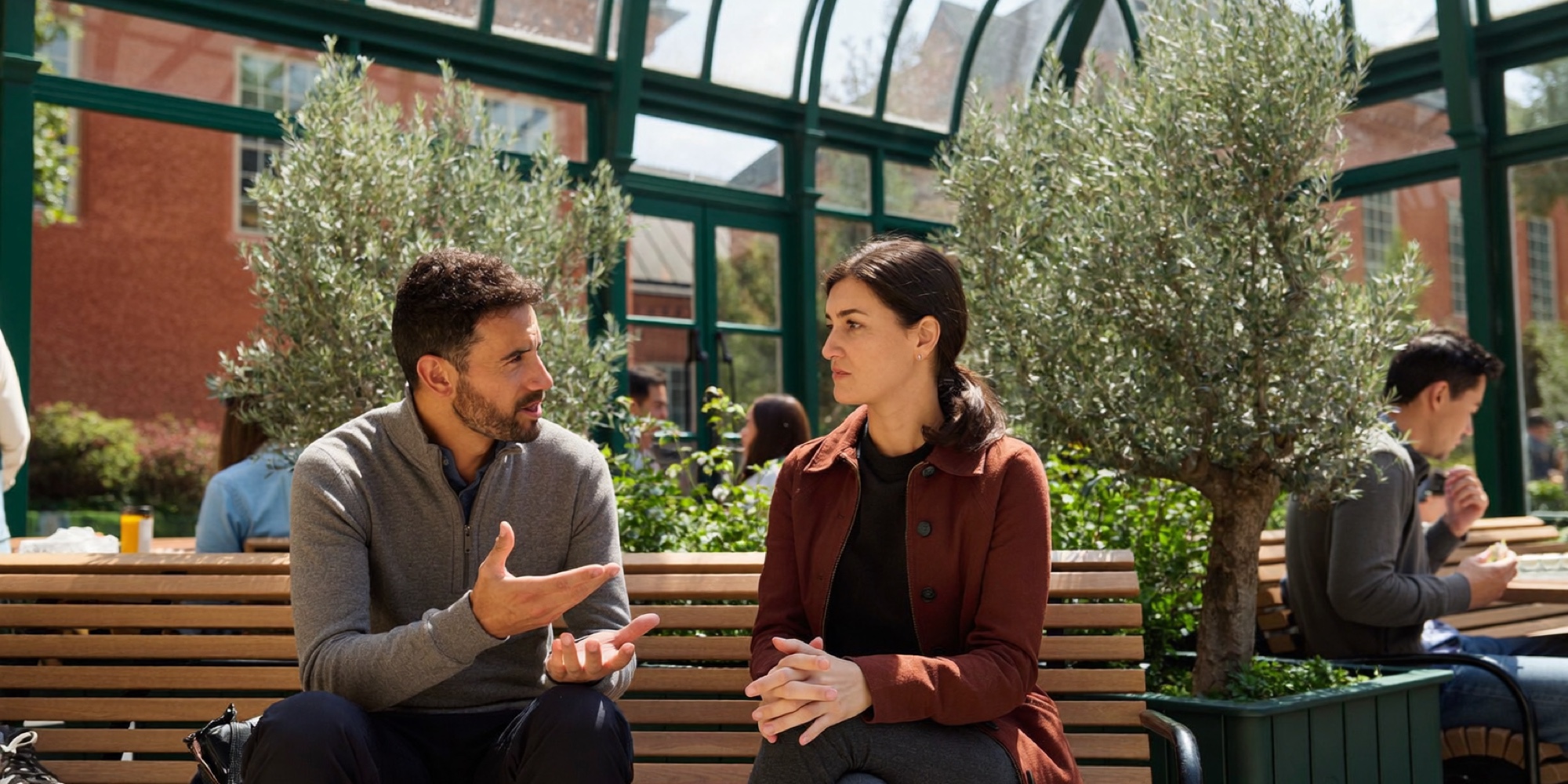 Two colleagues comparing the retirement plans of an old and a new employer