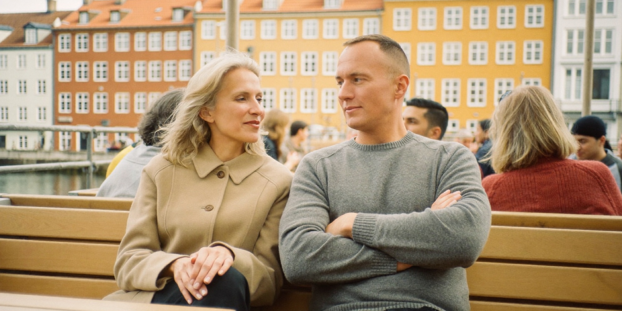 Two friends on a harbour terrace in the late afternoon, after the working day has ended