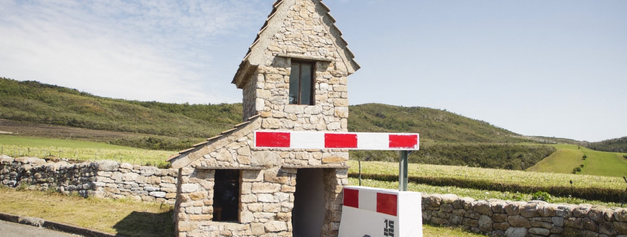 A country toll house, a picture of fees taken quietly along the way