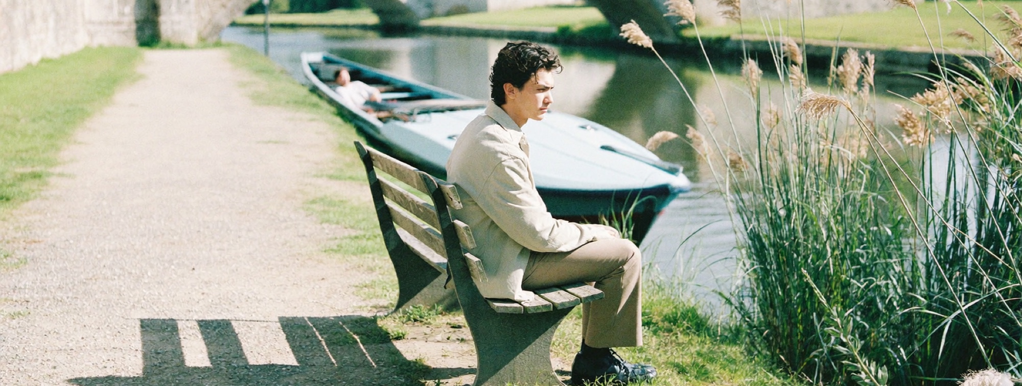 A man on a canal towpath choosing which way to go, a decision with two paths