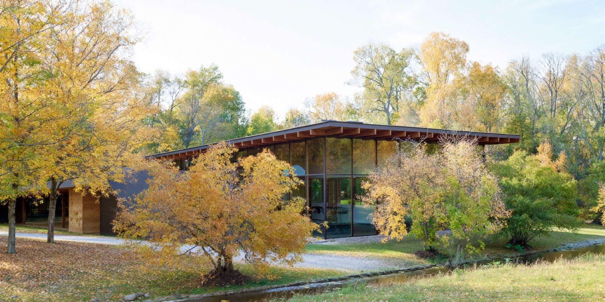 A wooded corporate campus beside a river, the kind of headquarters where a written culture gets built
