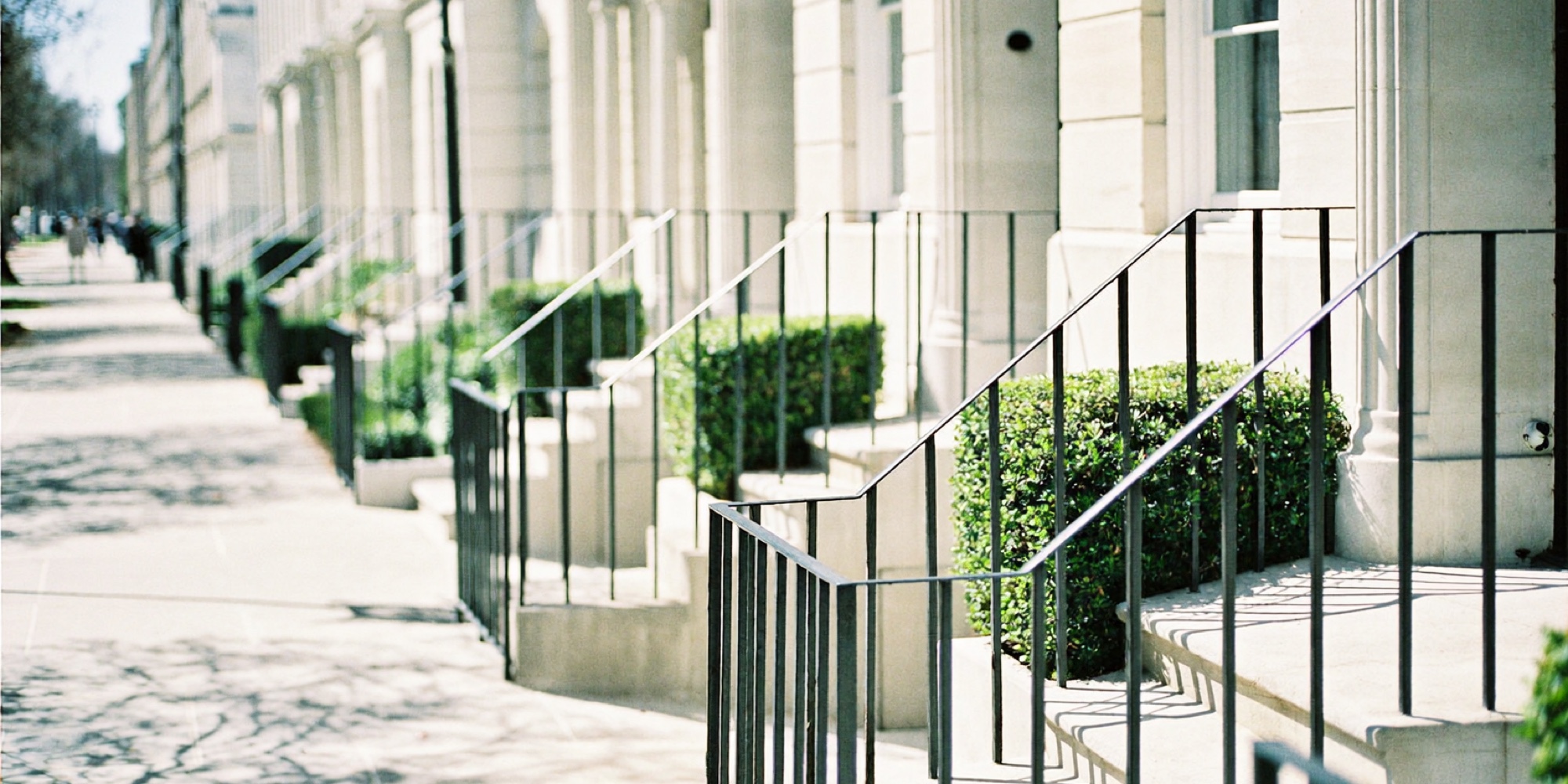 A terrace of limestone townhouses at midday, the asset that sits at the centre of most American balance sheets