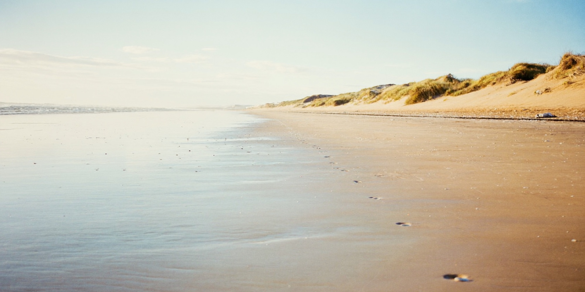 An empty beach at low tide, the kind of switched-off time that rebuilds stress tolerance
