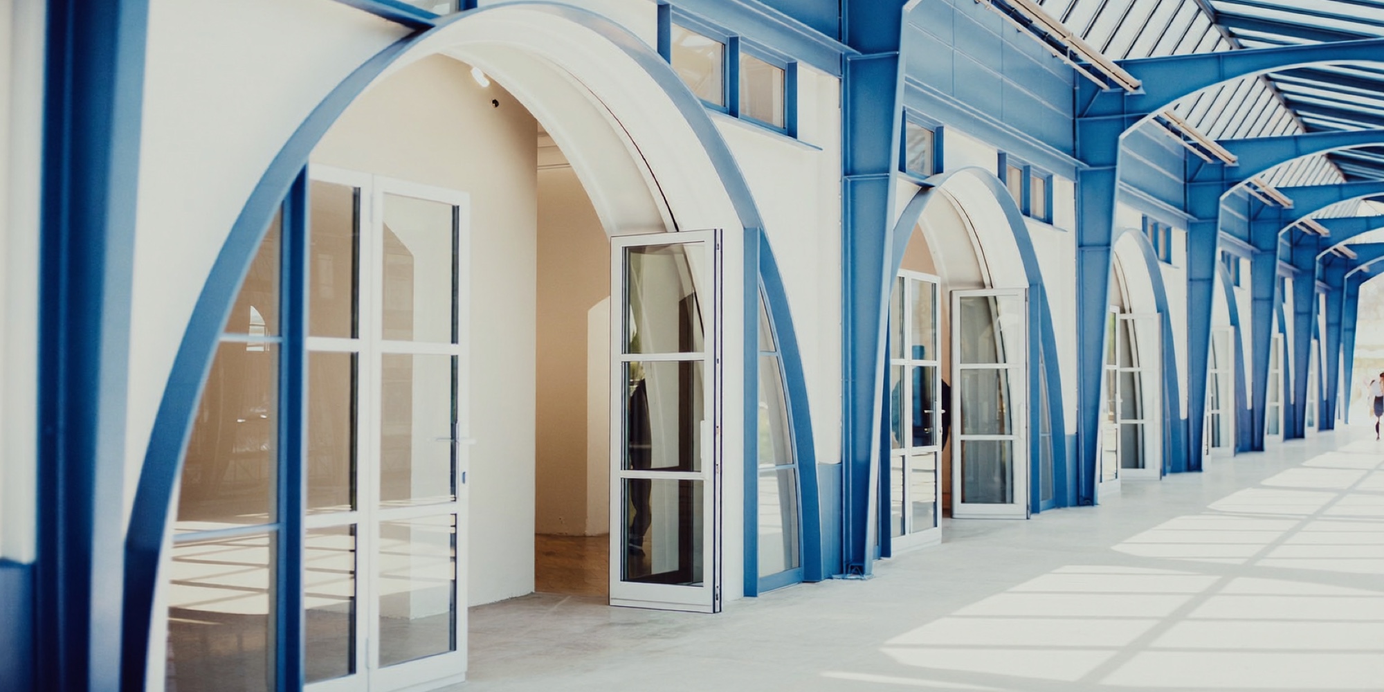 Three doorways in a bright arcade, three options that look alike until they are scored