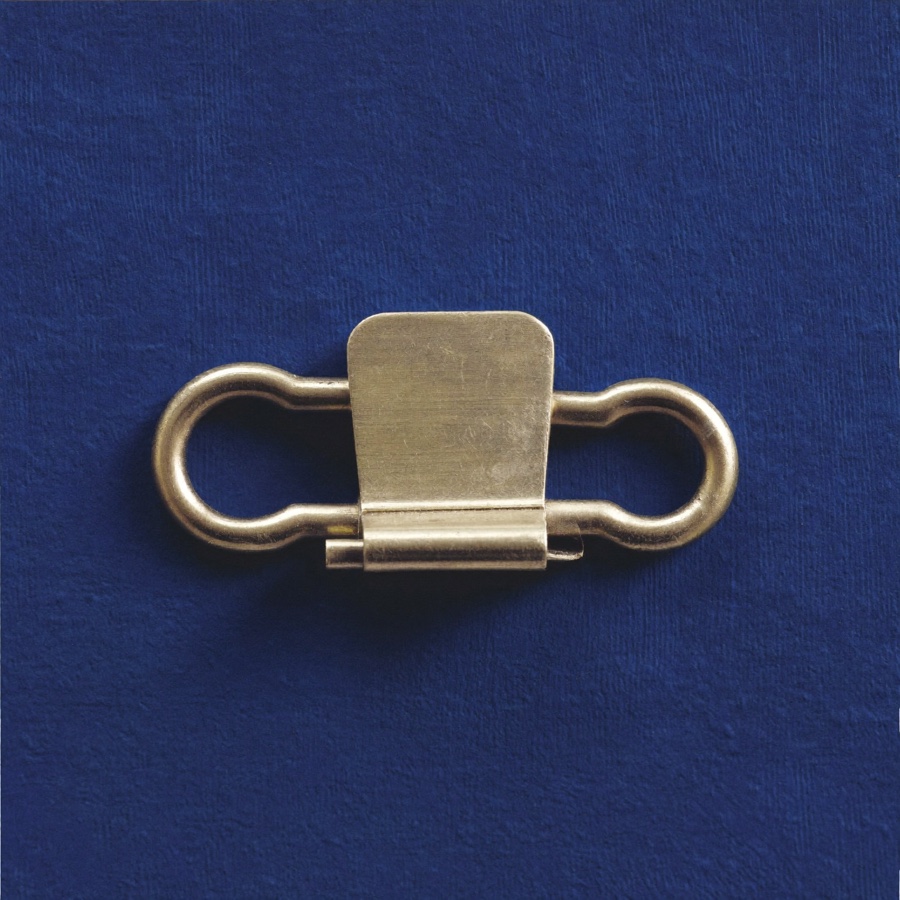 A brass bulldog clip, holding a claim to its source