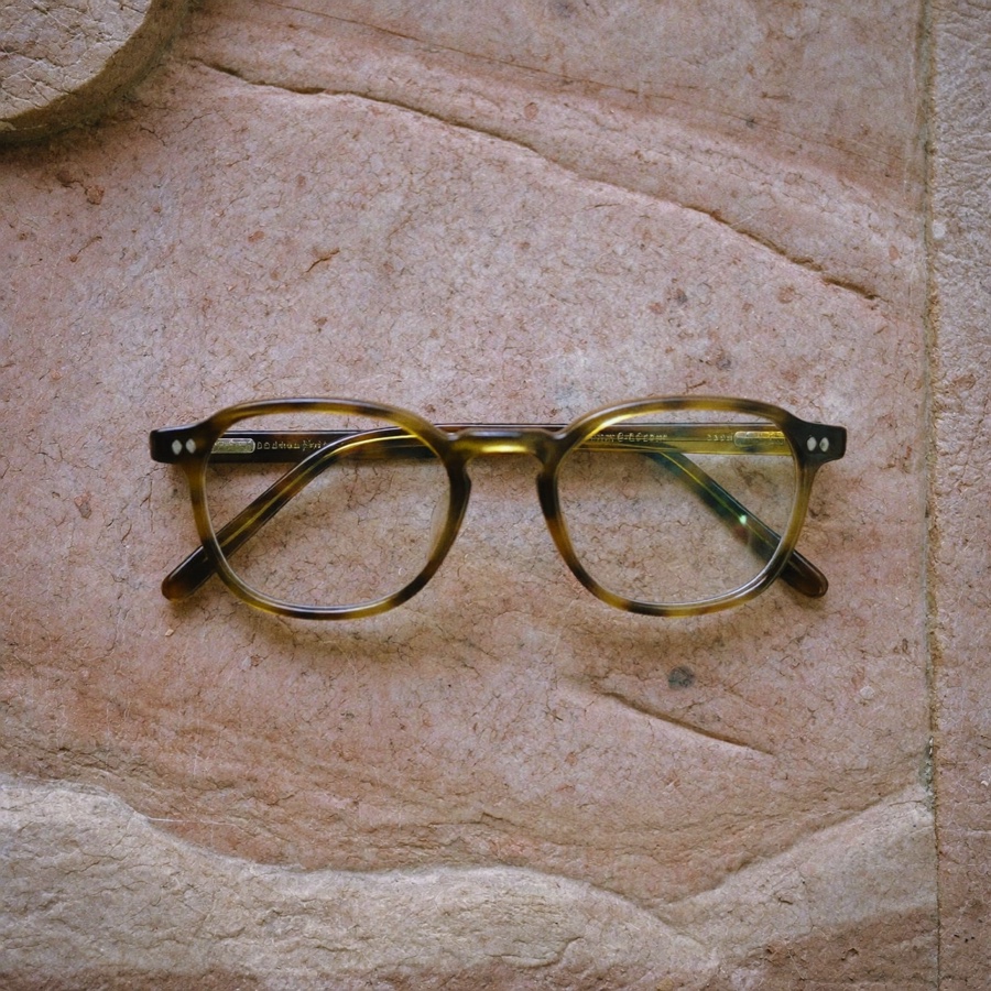 A folded pair of reading glasses, a small symbol of how to read more books