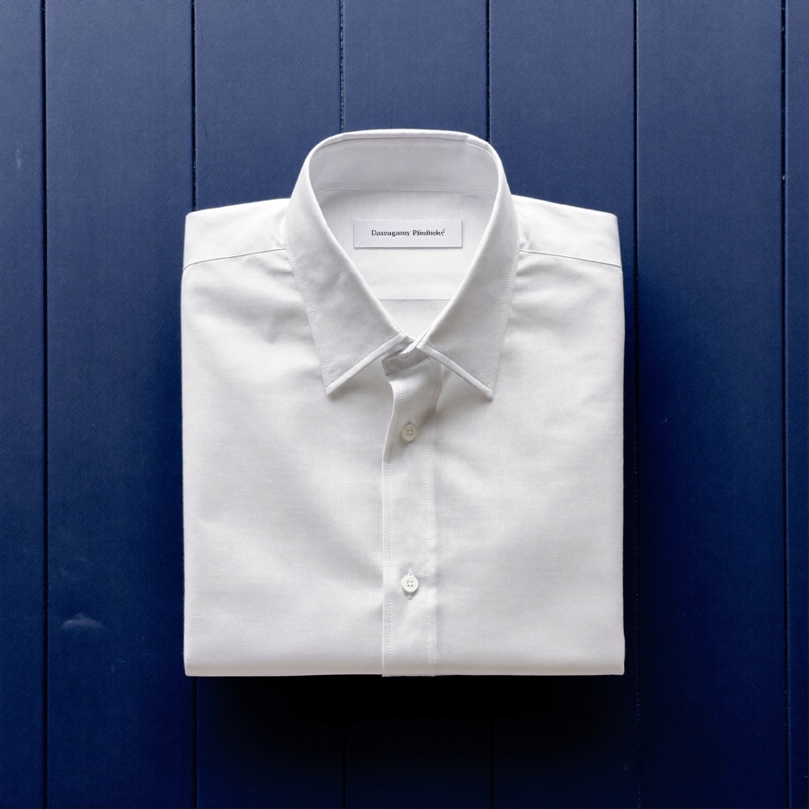 A white dress shirt folded for a carry-on