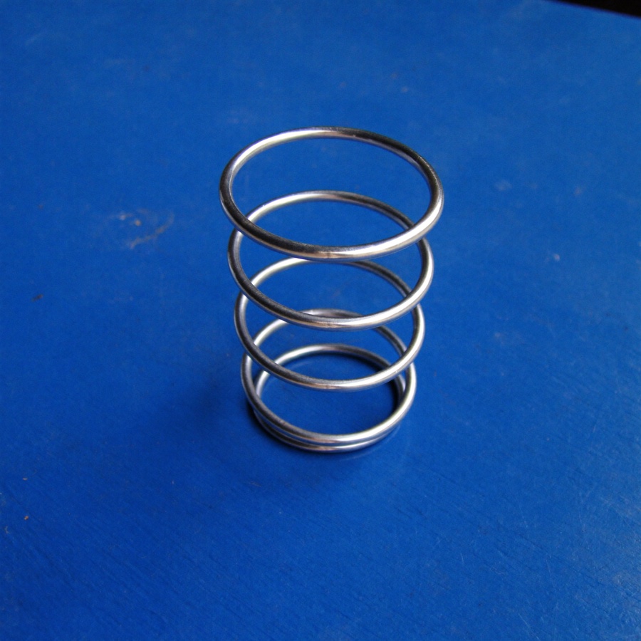 A single steel coil spring, an object that loads and recovers the way stress tolerance does