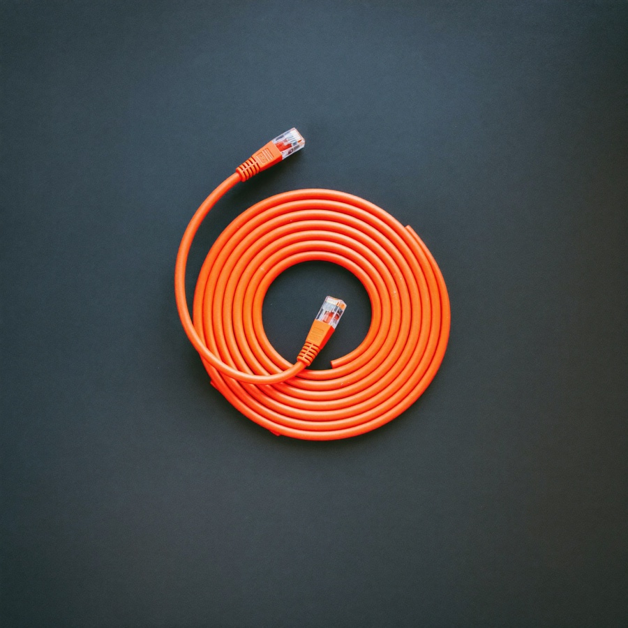 A coiled orange network cable, the plumbing behind a small business AI project