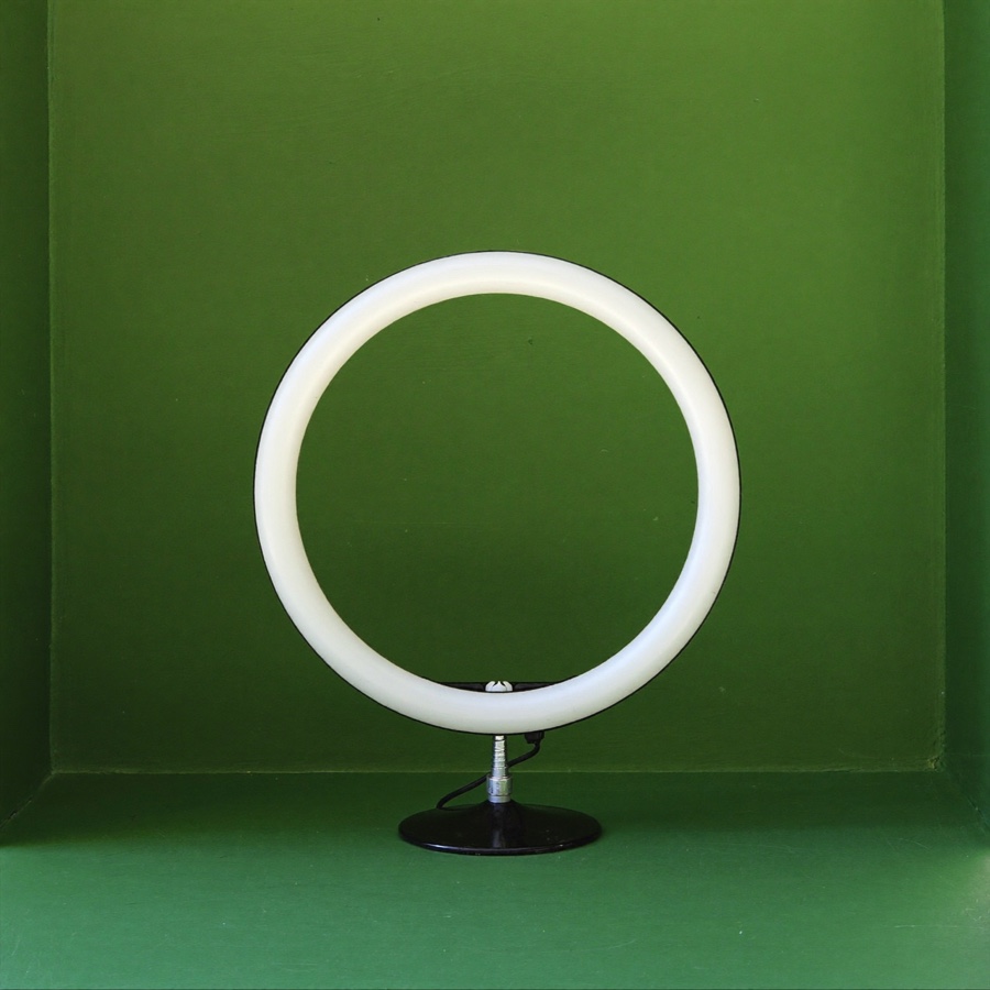 A round LED ring light switched off, for an article on what to post on LinkedIn when you run a business and have no wish to perform