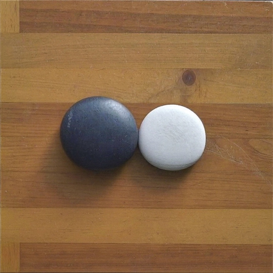 A black stone and a white stone side by side, for an article on dialectical thinking