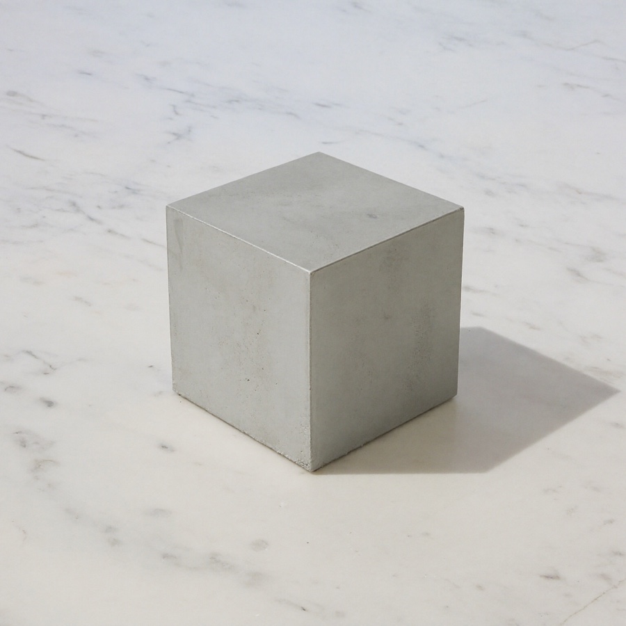 A small concrete cube on marble, for an article on concrete thinking
