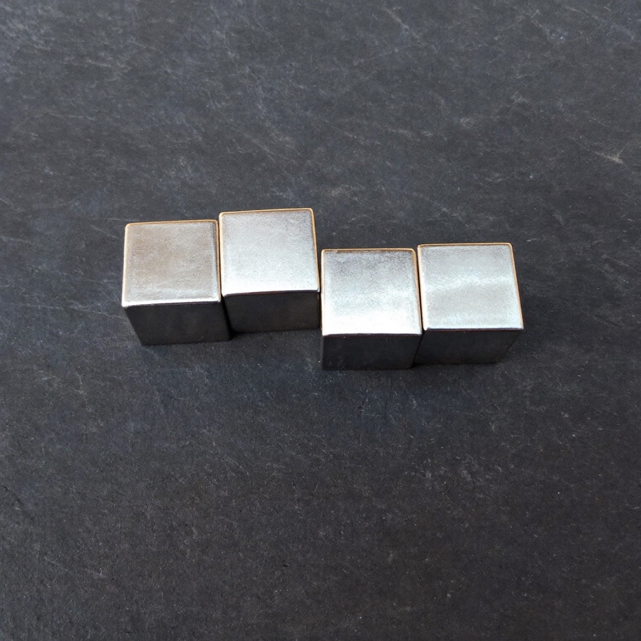 Four steel cubes in a row, for an article on the big 4 consulting firms